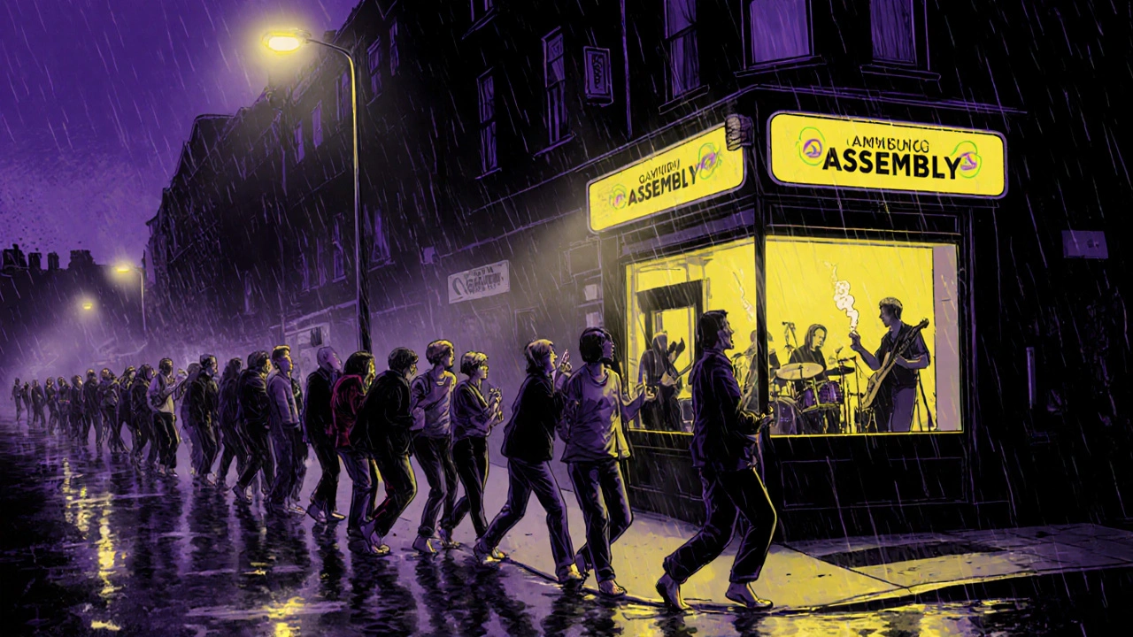 People lined up outside a music venue at night in the rain, dancing and sharing cigarettes under streetlights.