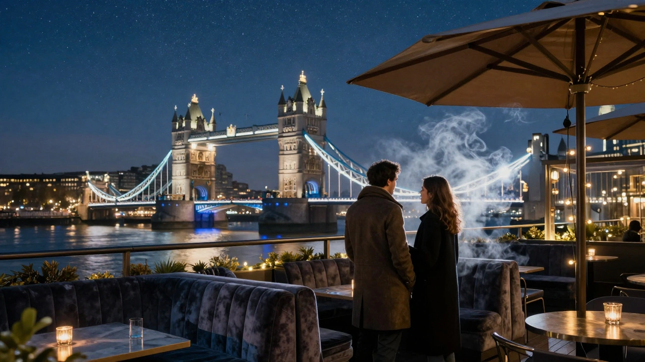 A couple on a heated rooftop terrace overlooking the Thames with Tower Bridge glowing in the night.