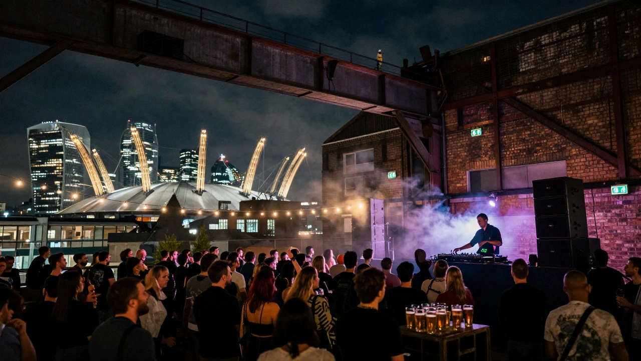 Industrial rooftop rave at Printworks with city lights and steel beams under a starry night sky.